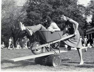Two students compete in the Devil Goat Day wheelbarrow contest in 1977. Photo courtesy of Simpson Library Special Collections.