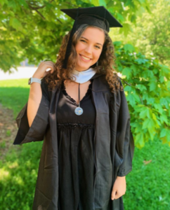 2020 graduate Anna Sager celebrates her bachelor's degree and shows off her graduation regalia on UMW's campus.