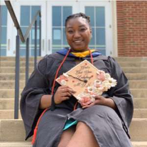 2020 graduate Danielle Norris celebrates her accomplishments and her degree from UMW's College of Business.