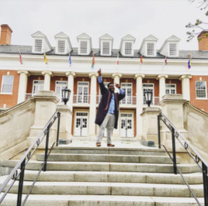 2020 graduate Jeremiah Ward celebrates completing his bachelor's degree in psychology on the steps of Lee Hall. Ward was the 2020 recipient of the Clara Boyd Wheeler Award at UMW's virtual Eagle Awards.