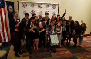 Ulmschneider (front, kneeling) with the 2017 "We The People" team, which he has coached to state and national championships.