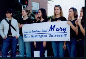 Borrowing the title from the comedic film, a group of students hold a banner reading "There Is Something About Mary, Mary Washington University" at the "Save the Name" rally in spring 2004 to protest the proposed idea of eliminating "Mary Washington" from the school's name. Photo courtesy of UMW Libraries' Special Collections and University Archives.