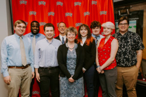 Adrienne Brovero (center, in black sweater) has coached the University’s nationally ranked intercollegiate policy debate team since arriving at Mary Washington in 2006. Shown here with members of the UMW team, Brovero coordinated with David Cram Helwich, director of forensics at the University of Minnesota, to coordinate tomorrow night's Debate Watch event.