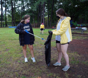 From left to right: Hannah Abraham and Jenna Montgomery help Friends of the Rappahannock by picking up trash in Kenmore Park. Photo by Suzanne Carr Rossi.