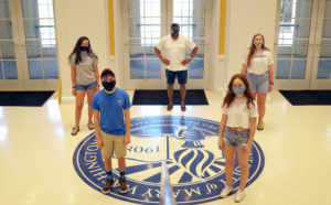 Dean of Student Life Cedric Rucker (back) joins UMW students inside the University Center. Campus well-being will depend on the individual actions of everyone when campus re-opens.