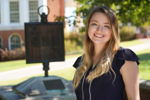 Senior Nichole Boigegrain is one of 34 UMW students elected to Phi Beta Kappa, one of the nation's oldest and most prestigious academic societies. Here, she stands with the PBK marker on Campus Walk. UMW's Kappa of Virginia chapter celebrates its 50th anniversary this fall. Photo by Suzanne Carr Rossi.