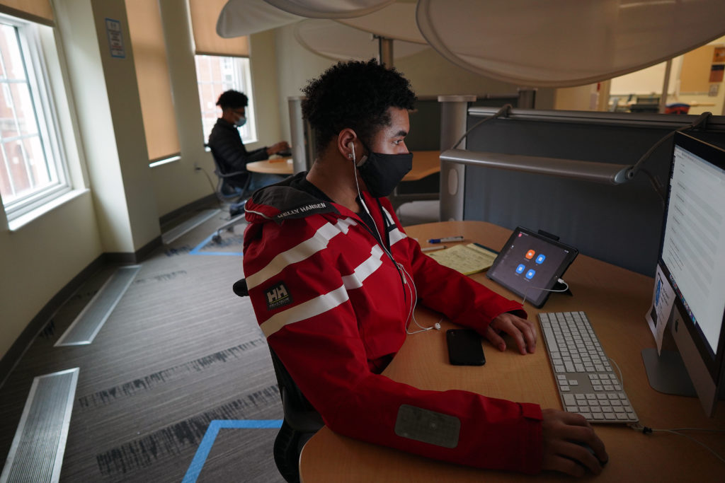 Junior Joseph Lewis completes an assignment in a workspace in UMW's Hurley Convergence Center. Photo by Suzanne Carr Rossi.