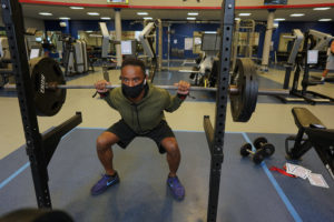 UMW employee Andre Reaves lifts weights in the UMW Fitness Center, which has spaced apart its workout equipment and is sanitizing between uses. Photo by Suzanne Carr Rossi.