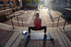 Senior Madeline Enderle leads a group of students in a late afternoon outdoor fitness class in Goolrick Courtyard next to the Anderson Center. Photo by Suzanne Carr Rossi.