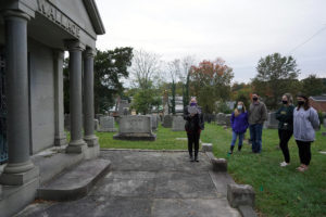 Senior Brianna Melick tells visitors about the cemetery's only mausoleum, and its occupants, Judge Alexander Wallace and wife Victoria, who both died in 1927. Photo by Suzanne Carr Rossi.