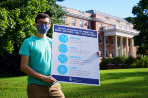 Most rules will remain the same during the spring semester, including MMDC: Monitor, Mask, Distance and Clean, in this sign displayed by UMW student David Miller. Students' adherence to this oft-repeated mantra helped keep UMW's COVID numbers down during the fall semester.