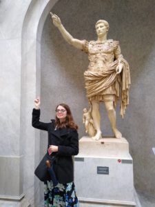 UMW senior Ruth Wilmot poses with the Primaporta Augustus statue, honoring the first emperor of the Roman Empire, during a study abroad trip to Rome prior to the pandemic. Mary Washington's classics program just earned the top spot on a student-curated list in College Magazine.