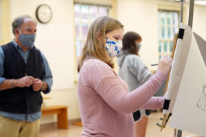 Sophomore Harper Northrup draws as Visiting Professor of Art Ashe Laughlin looks on. Photo by Suzanne Carr Rossi.