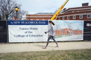 A student passes by Seacobeck Hall, which is under construction as the new home of UMW's College of Education and slated for completion early next year. Photo by Suzanne Carr Rossi.