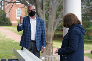 UMW College of Education (COE) Dean Pete Kelly talks with Professor of Education and Mathematics Marie Sheckels at a beam signing ceremony on the University of Mary Washington's Fredericksburg campus. The beam - signed by COE students, alumni and friends - was placed atop Seacobeck Hall. The longtime dining facility cherished by generations of Mary Washington alumni will be the new home of the COE. Photo by Suzanne Carr Rossi.