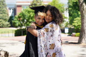 Monique Jones (right) gives her daughter, Reina Irby, a hug after one of three 2020 graduation ceremonies. Photo by Suzanne Carr Rossi.