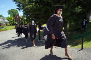 Sharon Johnson Theodore, MBA '20, leads processes from Sunken Road, where graduates lined up, onto the Campus Recreation Field, where this year's Commencement ceremonies were held. Photo by Suzanne Carr Rossi.