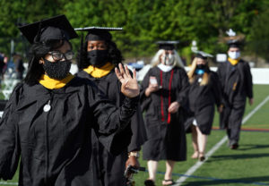 Graduates processed in from Sunken Road, waving to family and friends sitting in pods, eager to cheer them on. Photo by Suzanne Carr Rossi.