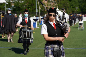 Eagle Pipe Band leader Lauren McMillan, who is also an associate professor of historic preservation at UMW, and drummer Helen Sande march the newly minted grads off the field. Photo by Suzanne Carr Rossi.