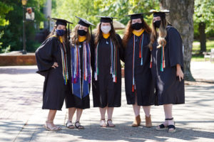 Donning decorated caps and colorful honors tassels, as well as the accessory of the year - protective masks - 2021 grads said goodbye to the Mary Washington campus and the friends they made over the last four years. Photo by Suzanne Carr Rossi.