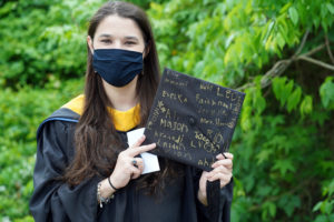 Stephanie Johnson holds up her mortar board that her kindergarten students signed for her graduation ceremony, where she received a M.S. in elementary education from UMW. Photo by Suzanne Carr Rossi.