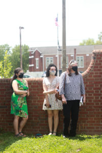 From left to right: UMW senior Jessica Lynch and junior Sydney Baylor, along with Fredericksburg Tourism Sales Manager Victoria Matthews, who helped Williams bring the project to fruition. Photo by Karen Pearlman.