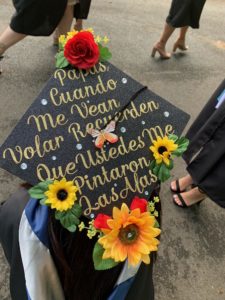 The message on the cap of biology major Daniela Sarai Chacon, who minored in Spanish, translates to: "Parents, when you see me fly, remember that you painted my wings."