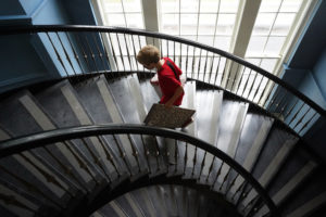A student ascends the spiral staircase during UMW Move-In Day, which welcomed undergrads from as far away as South Africa. Photo by Suzanne Carr Rossi.