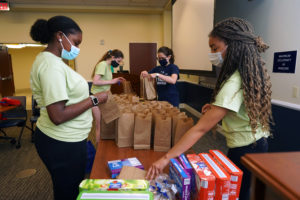 From left to right, Aniya Stewart, Michelle Snellings, Kaylee Deardorff and Cassidy Richardson assemble lunches for Micah Ecumenical Ministries. Photo by Suzanne Carr Rossi.