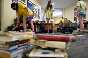 Students sort through donated books at the University Center before loading them onto the Fredericksburg Bookmobile. Photo by Suzanne Carr Rossi.