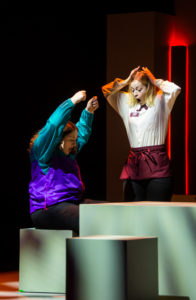 Shannon Hardy (R) as Barbara reacts after spilling a plate of food on the lap of a customer played by Amelia Emory. Photo by Geoff Greene.