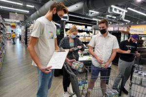 From left to right: Dustin Jenkins, Rebecca Alley, Preston Everett and Cameron Jackson discuss their project during their shift at the Co-op. Photo by Suzanne Carr Rossi.
