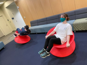 Victoria Gallaway took a photo of fellow UMW students Carter Bussey and Zoe Hanrahan having fun spinning in chairs in the Hurley Convergence Center.