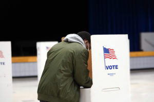 UMW senior Darius Reed fills out a ballot at Walker-Grant Middle School on Election Day. Photo by Suzanne Carr Rossi.