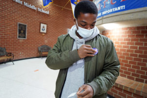 UMW senior Darius Reed dons a sticker showing he voted in today's election. Seventy-nine percent of University of Mary Washington students (higher than the national average) voted in the 2020 election. Photo by Suzanne Carr Rossi.