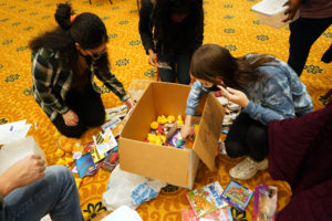 Merna Mousa (left) and Meghan McLees assemble Jared Boxes, which include small toys, crayons and coloring books, and games, to give to young patients at Mary Washington Hospital. Photo by Suzanne Carr Rossi.