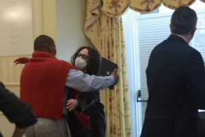 UMW Board of Visitors Rector Heather Crislip hugs Associate Vice President and Dean of Student Life Cedric Rucker at this morning's BOV meeting, during which Crisp read a resolution to rename the University Center in Rucker's honor. Photo by Karen Pearlman.