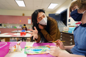 Chloe Wade offers guidance on using watercolors to one of her fifth-grade students. Photo by Suzanne Carr Rossi.