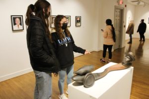A pair of UMW students discuss Syd Carpenter's sculpture "Frank in Tow."
