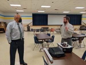 Washington & Lee High School Assistant Principal Wilfredo Hernandez (left) Naval Surface Warfare Center Dahlgren Division Director of Academic Engagement Michael Clark discuss the parameters of the Innovation Challenge @ Dahlgren. Washington & Lee High School in Montross was the first to accept the challenge, designed to highlight the importance of STEM education.