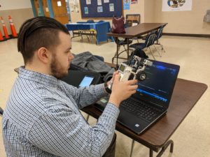 Michael Darnell, an engineer at the Naval Surface Warfare Center Dahlgren Division, works on coding the robot.