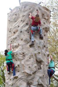 Students climb a rock wall set up in Jefferson Square for Devil-Goat Day. Photo by Suzanne Carr Rossi.