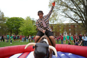 Brian Veranga, a Goat, rides the mechanical bull. Photo by Suzanne Carr Rossi.