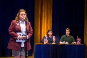 From left to right: Kaiti Edwards ’25 as Logainne SchwarzandGrubeniere in foreground and Taryn Snyder ’15 as Rona Lisa Peretti and Jon K. Reynolds ’07 as Vice Principal Douglas Panch. Photo by Geoff Greene.