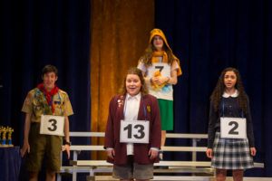 Back row, from left to right: Tommy Kelleher ’22 as Chip Tolentino, Nathan Marshak ’23 as Leaf Coneybear, Mina Sollars ’23 as Marcy Park. Front: Kaiti Edwards ’25 as Logainne SchwarzandGrubeniere. Photo by Geoff Greene.