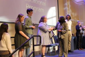 James Farmer Multicultural Center Director Marion Sanford presents the team that organized the Nonprofit Fair with the Outstanding Educational Program Award. Photo by Kayla Zegada.