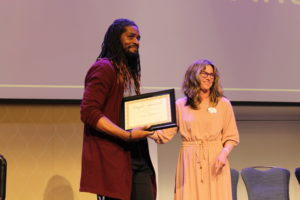 Michael Middleton, assistant director of Student Activities and Engagement, was presented with the Gwen Hale Giving Tree Award by last year's recipient, Betsy Southern. Photo by Kayla Zegada.