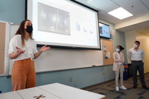 From left to right, UMW students Olivia Casey, Ayana Jefferson and Rogelio Santiago present "Effects of High Sugar and High Fat Diets on BDNF in the Hippocampus and Prefrontal Cortex on Working Memory in Mice." Mariana Haugh, not pictured, was also part of the group. Photo by Suzanne Carr Rossi.