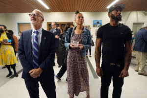 From left to right: President Troy Paino and Dr. Jones' niece and nephew, Venus Russell Whitties and Meredith Whitties, take in the mural dedicated last Friday honoring Dr. Venus Jones. Photo by Suzanne Carr Rossi.