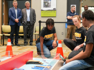 From left, U.S. Rep. Rob Wittman, R-Virginia, and University of Mary Washington’s Dr. John Burrow watch as King George high-schoolers Samantha Jones, Susan Randall and Ashton Jones compete in last year's debut of the Innovation Challenge @Dahlgren. Back right are UMW Assistant Professor of Special Education Kevin Good and Dahlgren Campus Director Michael Hubbard. The second annual event is set to take place March 31 to April 1, 2023. (U.S. Navy photo/Released)